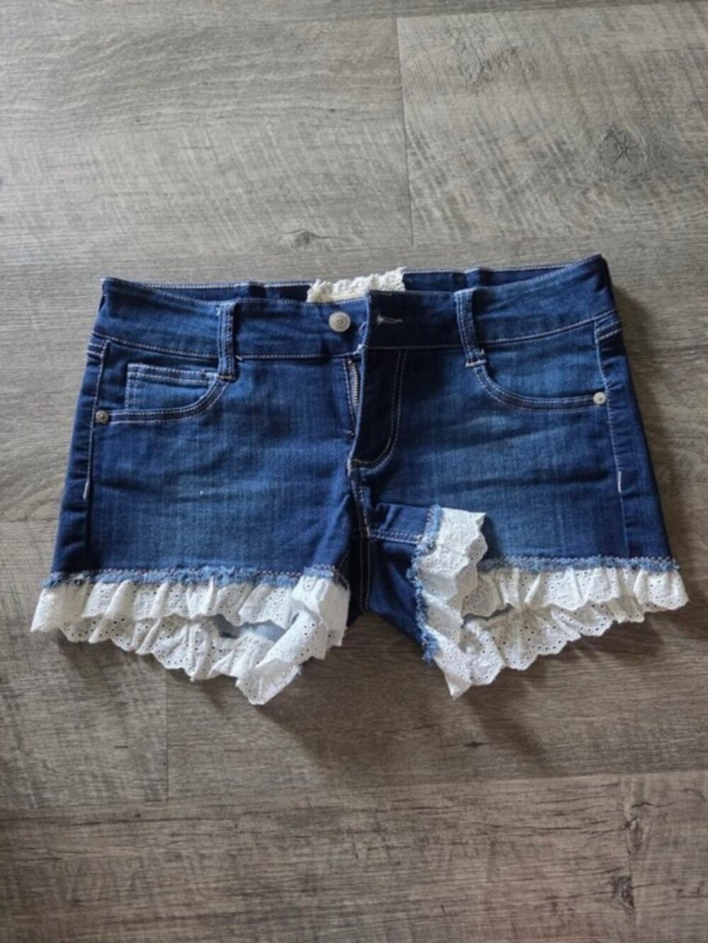 Altar'd State Dark Blue Denim Shorts with White Eyelet Lace Trim.